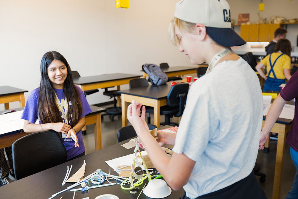 A UW student assists a camp attendee