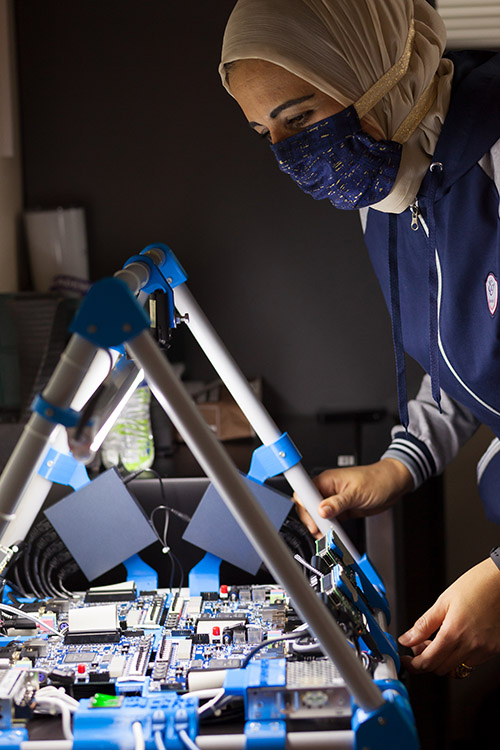 Rania Hussein working with a circuit board