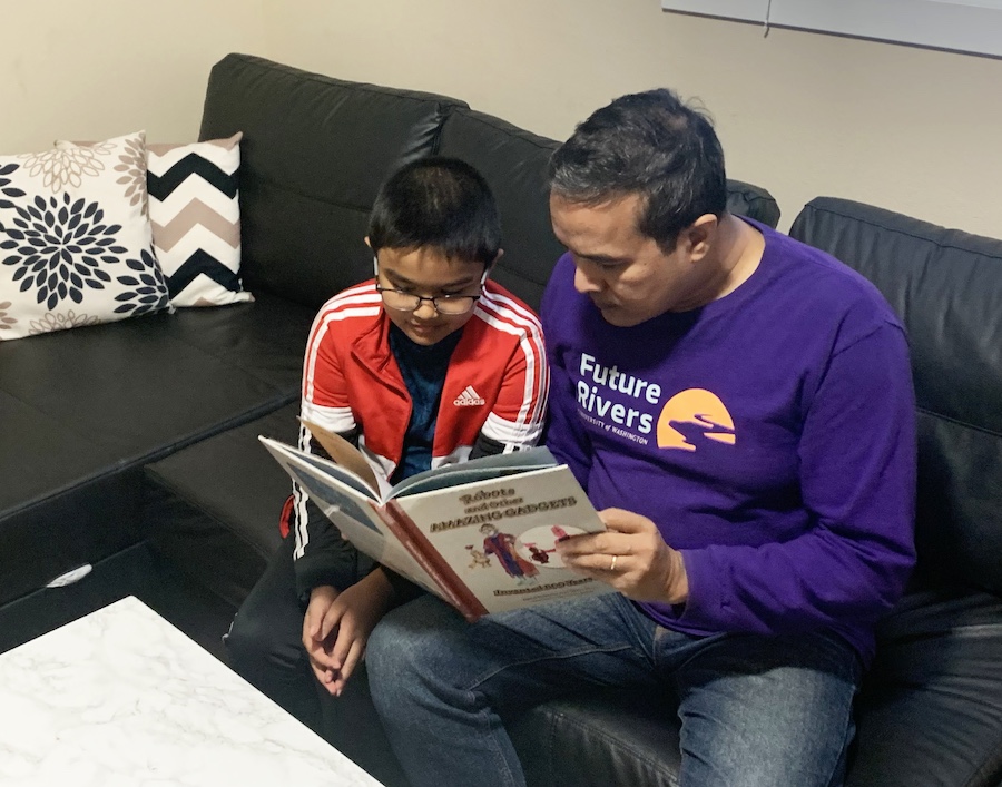 Man reading a book to a kid