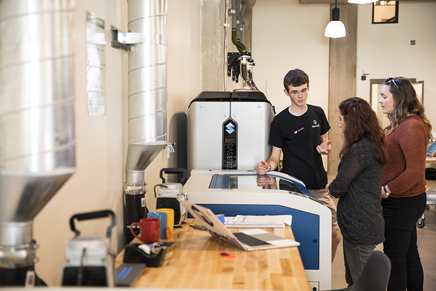 students with the Epilog Fusion M2 laser cutter