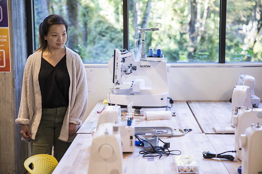 a student looks at sewing equipment