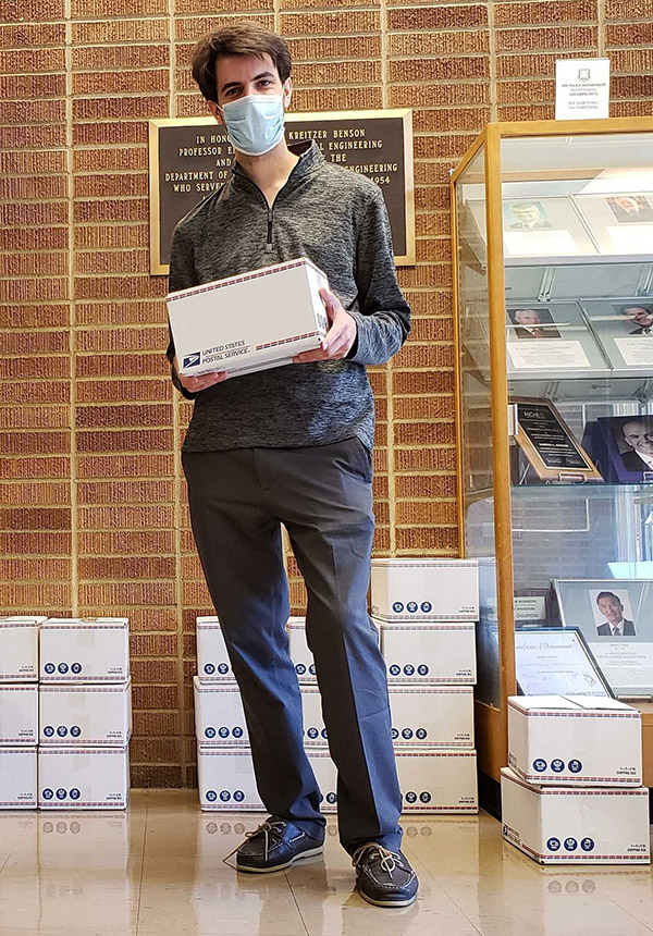 Man in a mask holding a priority mail box