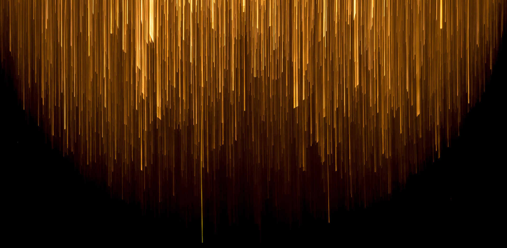 Golden light streaks against a black background