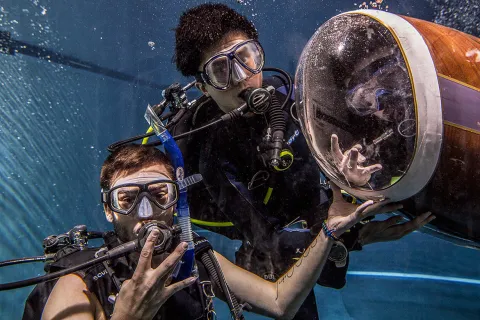 Dubs up! Dive team members Joe Zacharin and Timmy Lee and sub pilot Riley Harris.