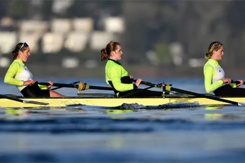 Three women rowers on the water