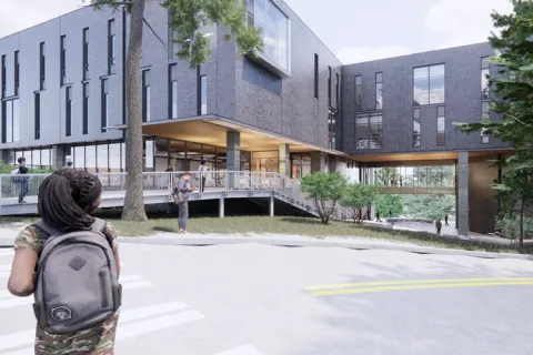 Exterior rendering: student walking towards the interdisciplinary engineering building