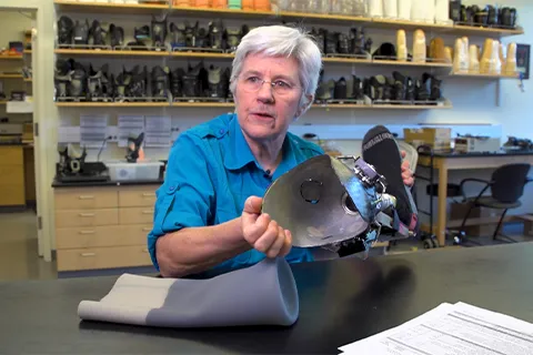 Joan Sanders, a UW professor of bioengineering, holds a prototype auto-adjusting prosthesis that her team developed.