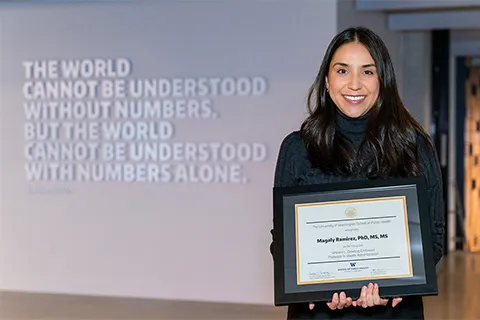 Maggie Ramirez holding a diploma