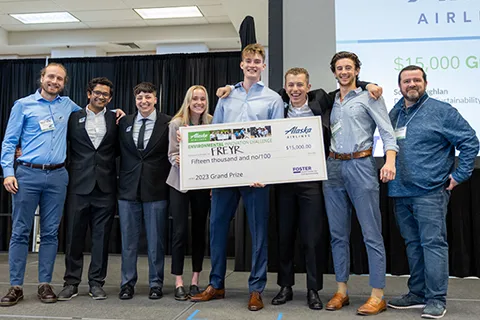 Group photo of 1st place winners of the 2023 Alaska Airlines Environmental Innovation Challenge holding a big check award