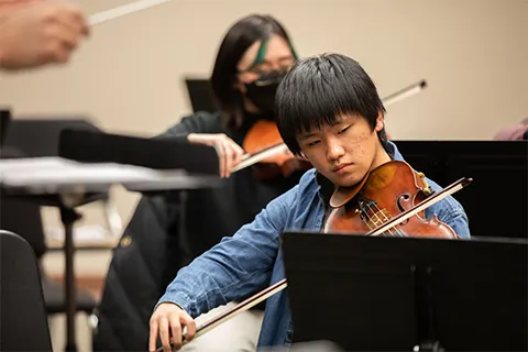 Male student playing viola
