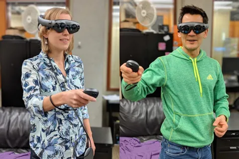 Two people wearing virtual reality goggles