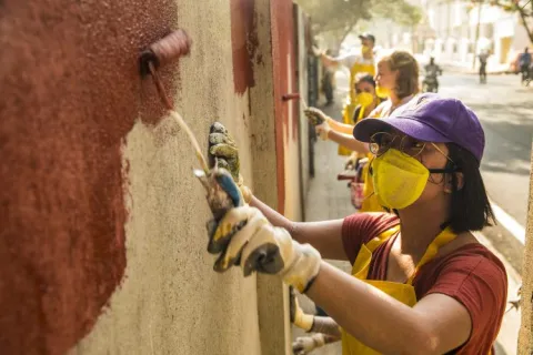 students painting an external wall