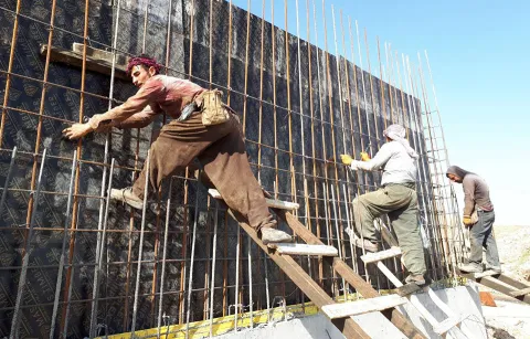 Men building a wall