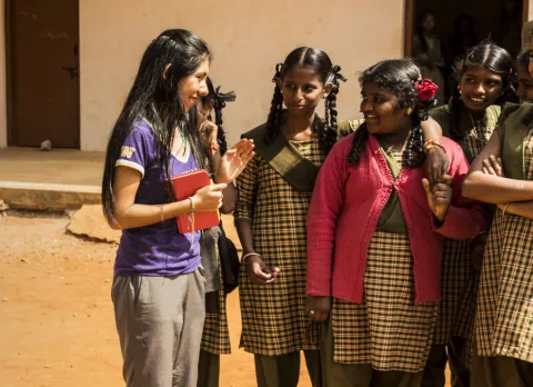 UW student speaking with a group of female Indian students