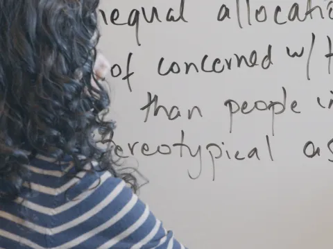 person writing on a whiteboard