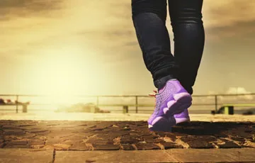 photo of person's legs and exercise shoes walking