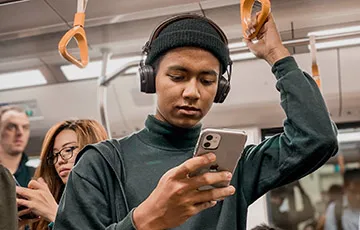 Person on a train looking at a smartphone