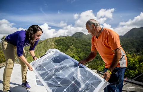Researchers installing solar panels