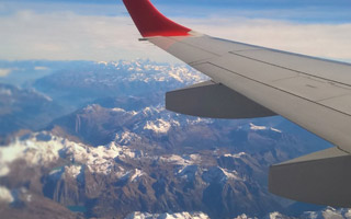 Airplane flying through mountain landscape